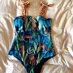 One piece with tropical print new never worn with pad. Runs small XL with mesh